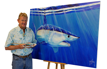 Guy Harvey standing in front of shark painting